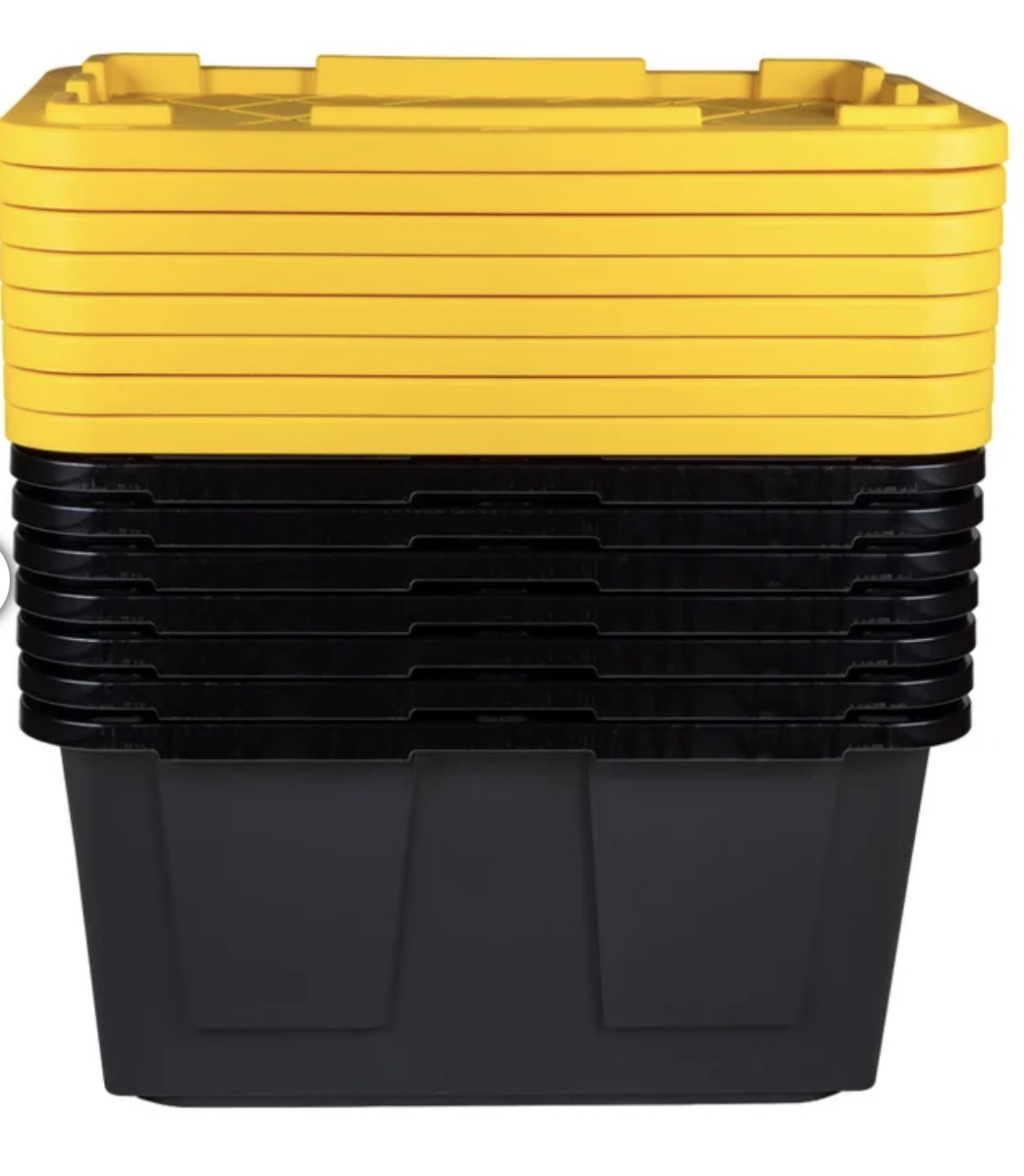 Moving bins stacked with yellow lids showing